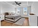 A spacious main bedroom featuring tray ceiling, ceiling fan, and large windows at 1216 Newell Dr, Myrtle Beach, SC 29588