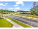 Community view showcasing the landscaped grounds, clubhouse and tennis courts at 1216 Newell Dr, Myrtle Beach, SC 29588