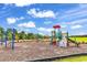 Community playground with slide, climbing area, swings and green space for children at 1216 Newell Dr, Myrtle Beach, SC 29588