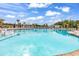 Relax in the expansive community pool with plenty of seating and tropical palm trees at 1216 Newell Dr, Myrtle Beach, SC 29588