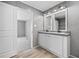 Well-appointed bathroom with a double vanity, wood-look flooring, and a doorway leading to the bedroom, offering a luxurious feel at 1301 Rabbit Ln., Conway, SC 29526