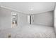 Spacious bedroom showcasing plush carpeting, neutral walls, and access to an en-suite bathroom, offering comfort and privacy at 1301 Rabbit Ln., Conway, SC 29526