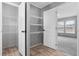 Organized walk-in closet with built-in shelving and wood-look flooring, offering ample storage space at 1301 Rabbit Ln., Conway, SC 29526