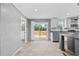 Open-concept kitchen with sliding glass doors, white cabinetry, stainless steel appliances, and a grey center island at 1301 Rabbit Ln., Conway, SC 29526