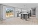 Bright kitchen features a gray island, stainless steel appliances, and sliding glass door onto an outdoor deck at 1301 Rabbit Ln., Conway, SC 29526