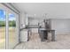 Bright, open kitchen with sliding door to the deck, stainless appliances, white cabinetry and grey countertops and island at 1301 Rabbit Ln., Conway, SC 29526