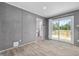 Bright living area with sliding glass doors, neutral walls, and light-colored wood flooring, offering great natural light at 1301 Rabbit Ln., Conway, SC 29526