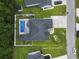 Overhead view of a private backyard featuring a sparkling swimming pool, spacious patio area, and mature trees for privacy at 144 Baylee Circle, Aynor, SC 29544