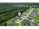 Aerial view of a peaceful residential neighborhood featuring well-maintained homes, lush greenery, and a serene natural backdrop at 144 Baylee Circle, Aynor, SC 29544
