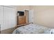 Cozy bedroom features a wooden dresser with mounted TV and a closet with bi-fold doors at 144 Baylee Circle, Aynor, SC 29544