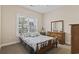 Bedroom with neutral carpet, a light blue color scheme, and a bright window with a treelined view at 144 Baylee Circle, Aynor, SC 29544
