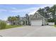 Spacious single-Gathering home with a large driveway, attached garage, well-maintained lawn, and inviting curb appeal at 144 Baylee Circle, Aynor, SC 29544