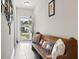 Welcoming hallway with wooden bench and patriotic pillows, leading to the front door at 144 Baylee Circle, Aynor, SC 29544