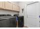 Laundry room featuring modern washer and dryer, lots of storage and tiled floor at 144 Baylee Circle, Aynor, SC 29544