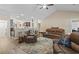 Comfortable living room with vaulted ceilings, leather furniture, and seamless flow to the kitchen at 144 Baylee Circle, Aynor, SC 29544