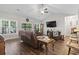 Open living room with hardwood floors, vaulted ceiling and lots of natural light from the many windows at 144 Baylee Circle, Aynor, SC 29544