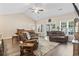 Spacious living room features vaulted ceilings, wood floors, and comfortable seating with lots of natural light at 144 Baylee Circle, Aynor, SC 29544
