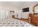 Bright main bedroom featuring a ceiling fan, closet, and warm, neutral color scheme at 144 Baylee Circle, Aynor, SC 29544