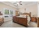Cozy primary bedroom with a neutral color palette, a ceiling fan, and a large window for natural light at 144 Baylee Circle, Aynor, SC 29544