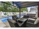 Inviting outdoor living space featuring a fire pit, cozy seating, and a pool for relaxation and entertainment at 144 Baylee Circle, Aynor, SC 29544