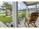 Inviting covered porch with rocking chairs overlooking a well-manicured front yard with palm trees and tasteful landscaping at 144 Baylee Circle, Aynor, SC 29544