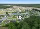 Aerial view of neighborhood homes, featuring a lake and wooded spaces at 1448 Tiger Grand Dr., Conway, SC 29526