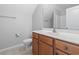 Cozy bathroom with wood cabinets, neutral countertops, and a toilet at 1448 Tiger Grand Dr., Conway, SC 29526