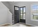 Home entryway featuring a black front door and stairs at 1448 Tiger Grand Dr., Conway, SC 29526