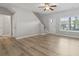 Bright living room with wood-look floors, ceiling fan, and stairs at 1448 Tiger Grand Dr., Conway, SC 29526