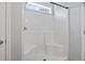 Bright white shower stall with a small window and built-in seats at 1448 Tiger Grand Dr., Conway, SC 29526