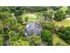 Overhead view of a clubhouse with a golf course, lush trees, and a winding walking path at 149 Old Cedar Loop, Pawleys Island, SC 29585