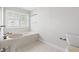 Bright bathroom featuring a vanity, large tub, and bright window at 149 Old Cedar Loop, Pawleys Island, SC 29585