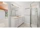 Bright bathroom with white vanity, shower, and a large mirror at 149 Old Cedar Loop, Pawleys Island, SC 29585
