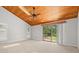 Bright bedroom with wood-paneled ceiling and large sliding door window overlooking the back yard at 149 Old Cedar Loop, Pawleys Island, SC 29585