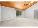 Bright bedroom with wood-paneled ceiling and large sliding door window overlooking the back yard at 149 Old Cedar Loop, Pawleys Island, SC 29585