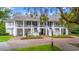 Charming two-story building with dual staircases, offering classic Southern charm and curb appeal at 149 Old Cedar Loop, Pawleys Island, SC 29585