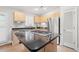 This eat-in kitchen includes an island cooktop, updated stainless steel refrigerator, and modern countertops at 149 Old Cedar Loop, Pawleys Island, SC 29585