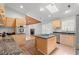 Bright kitchen with stainless appliances, island cooktop, granite counters, skylight, and direct access to the living area at 149 Old Cedar Loop, Pawleys Island, SC 29585