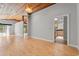 Large living room with hardwood floors, wood-paneled ceiling, and access to the kitchen at 149 Old Cedar Loop, Pawleys Island, SC 29585