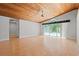 Large living room with wood floors, wood ceiling, ceiling fan, and sliding glass doors at 149 Old Cedar Loop, Pawleys Island, SC 29585