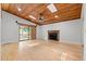 Large living room with wood ceilings, fireplace, and access to the porch at 149 Old Cedar Loop, Pawleys Island, SC 29585
