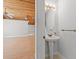 Elegant powder room featuring a pedestal sink, decorative mirror, and wood ceiling at 149 Old Cedar Loop, Pawleys Island, SC 29585