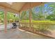 Screened in patio with tiled floors, outdoor furniture, and bright greenery at 149 Old Cedar Loop, Pawleys Island, SC 29585