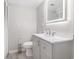 Modern bathroom featuring a vanity with LED mirror, white toilet, brushed nickel hardware and modern gray flooring at 1500 Cenith Dr. # B-403, North Myrtle Beach, SC 29582