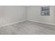 Clean bedroom featuring fresh paint, modern gray flooring, a window and neutral decor at 1500 Cenith Dr. # B-403, North Myrtle Beach, SC 29582