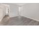 Spacious, freshly painted bedroom with modern gray floors and an open doorway into another room at 1500 Cenith Dr. # B-403, North Myrtle Beach, SC 29582