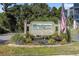 Well-manicured community sign with an American flag, enhancing curb appeal at 1500 Cenith Dr. # B-403, North Myrtle Beach, SC 29582