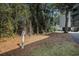 Designated dog walking area surrounded by lush trees, providing a private space for pet owners at 1500 Cenith Dr. # B-403, North Myrtle Beach, SC 29582