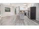 Bright, modern kitchen and dining area features stainless appliances and stylish light-grey wood-look flooring at 1500 Cenith Dr. # B-403, North Myrtle Beach, SC 29582