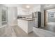 Bright kitchen featuring stainless steel appliances, white cabinets, a butcher block island top and stylish gray flooring at 1500 Cenith Dr. # B-403, North Myrtle Beach, SC 29582